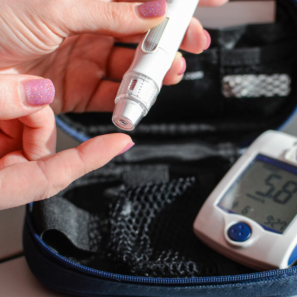 Woman using diabetes test strip